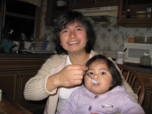 BestCooks-Lily Cervantes feeds organic yogurt to her daughter, Catalina 